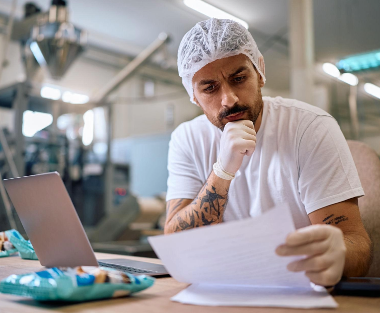 Fresh produce processing manager reviewing production performance in a vegetable processing facility.
